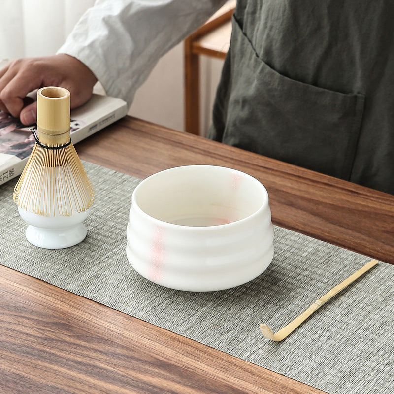White matcha making kit with pink shadow detail, laid out for preparation – Evonouk